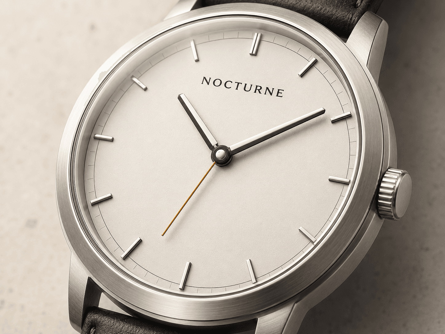 Close detail of the Atria porcelain dial, brushed case, sapphire edge, and crown